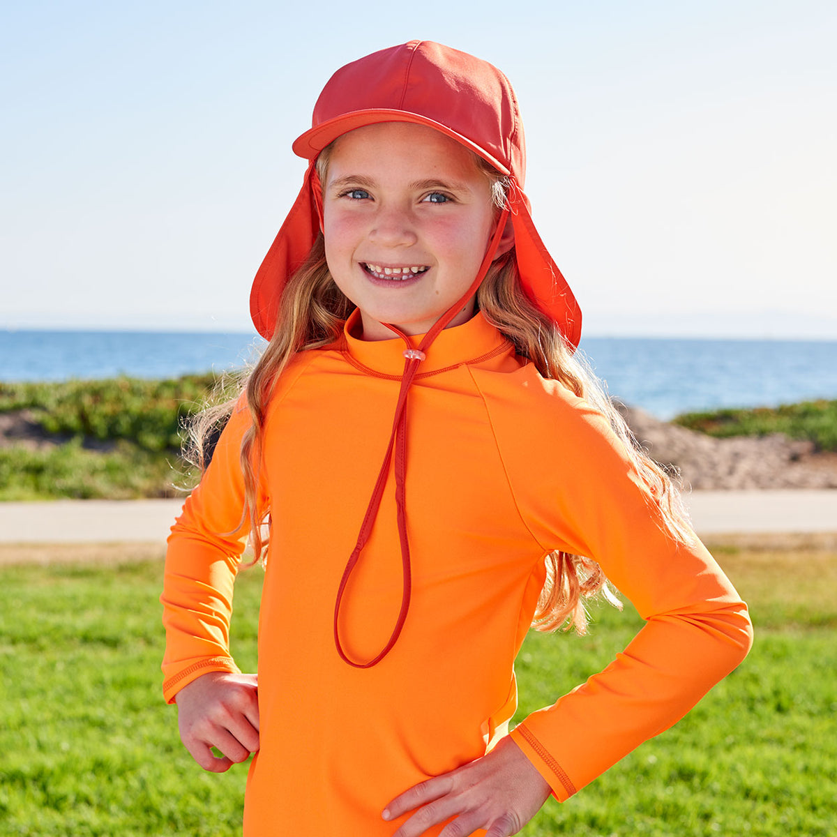Kids Orange Legionnaire Sun Hat Upf 50 Size S Xl Boys Girls Unisex Left View Girl Wearing an Orange Hat on a Sunny Day Sunpoplife