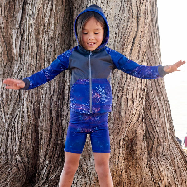 Cosmos Sunblocker Shorts Upf50 Kids Boys Girls Size 2 12 Purple Unisex Girl On The Beach Balancing On Tree Roots Sunpoplife
