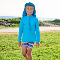 Island Blue Kids Long Sleeve Rash Guard Top Upf50 Boys Girls Unisex Size 2 12 Boy Walking on a Grassy Patch by the Beach Sunpoplife