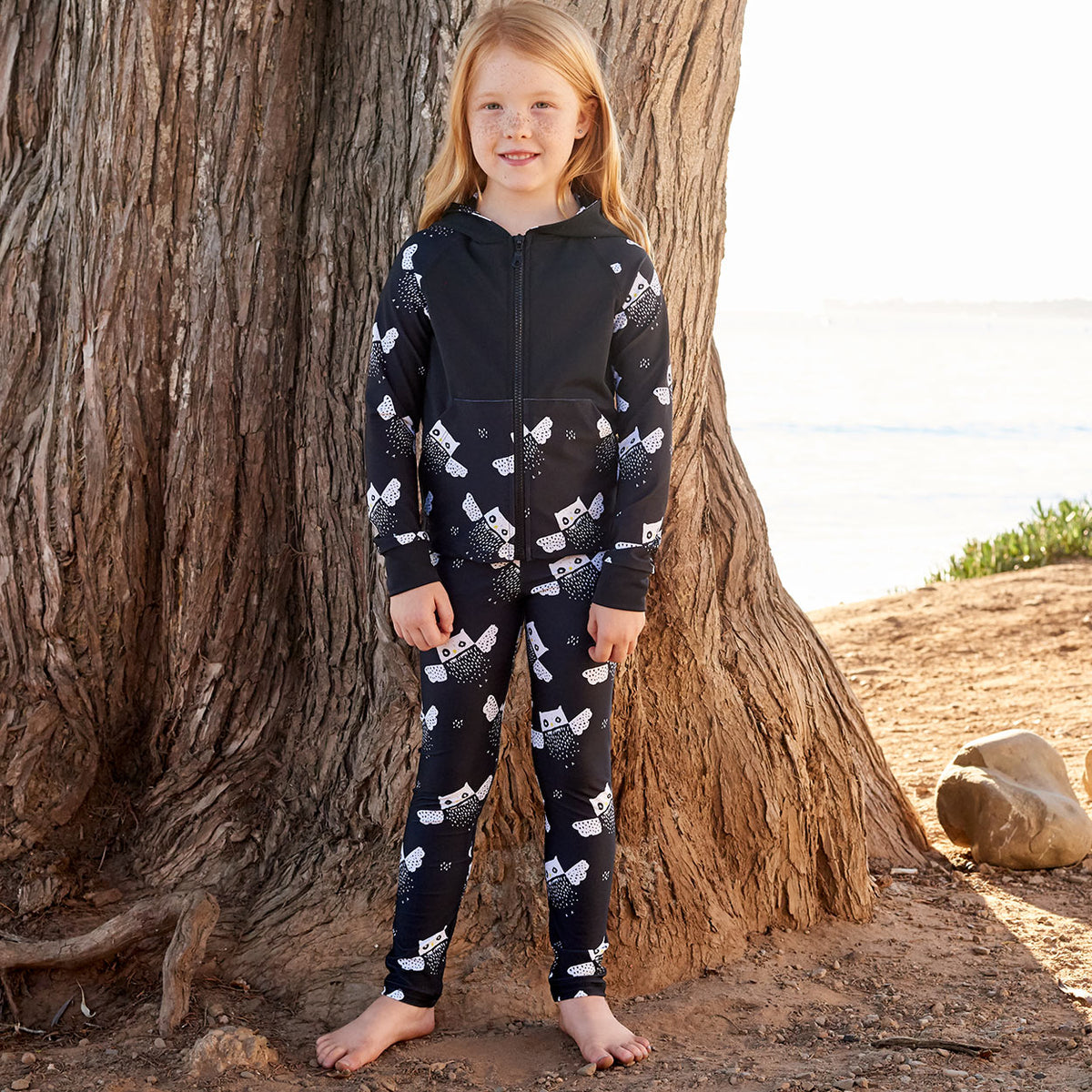 Owls Sunblocker Leggings Upf50 Black White Unisex Boys Girl Size 2 6 Girl Wearing An Athleisure Outfit Standing By The Beach Sunpoplife