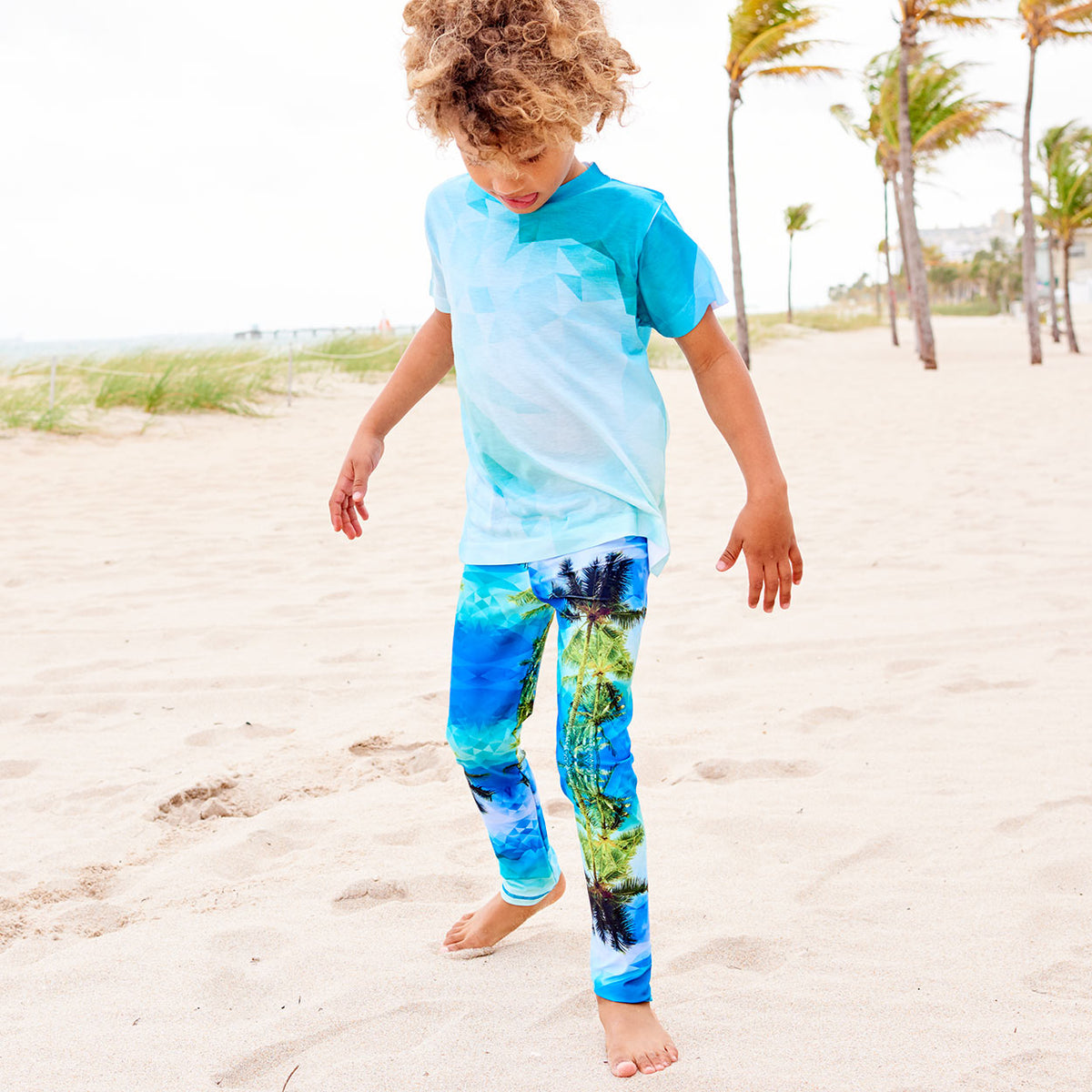 Palm Trees Hybrid Leggings Upf50 Kids Boys Girls Kids 2 6 Green Blue Unisex Geo Tropical Boy Wearing Sun Protective Leggings By The Beach Sunpoplife